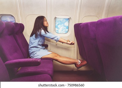 Asian Woman Passenger Relaxing At The Business Class Of Airplane 