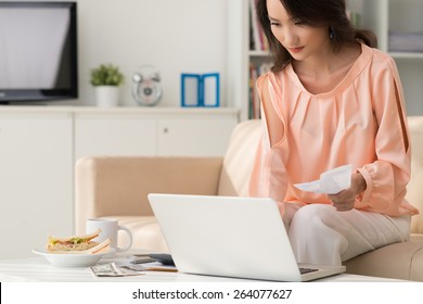 Asian Woman Paying Her Bills Online