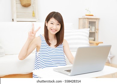 Asian Woman Peace Sign Gesture With PC