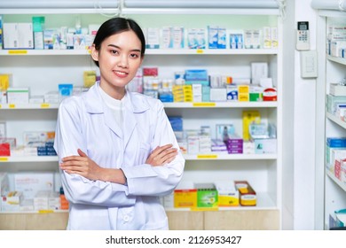 Asian woman pharmacist, chemist woman standing in pharmacy drugstore	