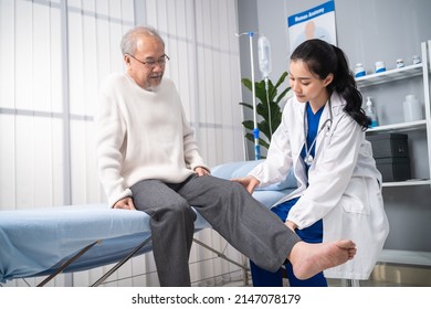 Asian woman physician doing legs raise exercise for senior man patient. Attractive female specialist doctor doing physical therapy procedure for elderly mature male to stretch and recover legs muscle. - Powered by Shutterstock