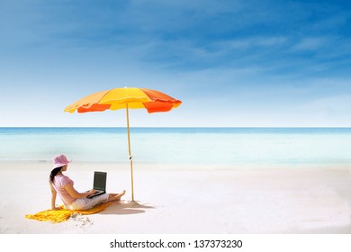 Asian Woman With Pink Hat Working On The Beach In Queensland, Australia