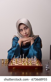 Asian woman playing chess