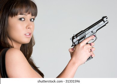 woman pointing gun at goldfish stock photo
