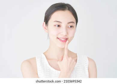 Asian Woman Pointing At Her Mouth