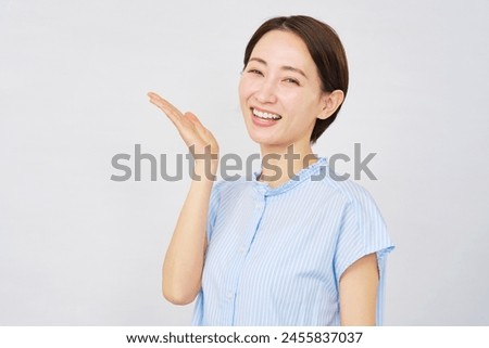 Asian woman pointing side in white background