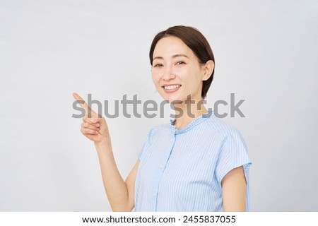 Asian woman pointing side in white background