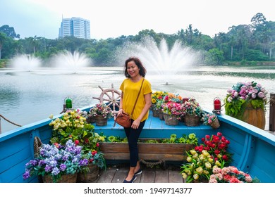 Asian Woman Posing In Beautiful Park Behind Senayan Park Mall Jakarta, Indonesia Where People Go And Take Their Own Pictures