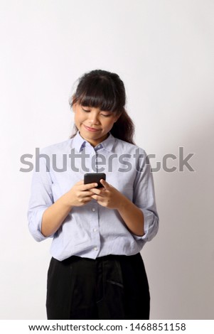 The Asian woman posing on the white background.