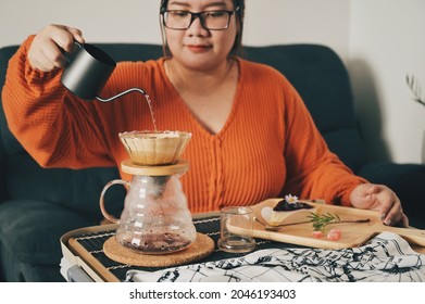 Asian Woman Pouring Over Coffee With Dripper For Brewing Coffee At Home. Enjoyed The Bakery And Coffee.