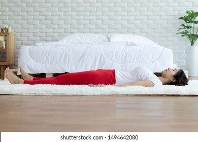 Asian woman practice yoga Dead Body or Savasana pose with meditation smile at home Feeling so comfortable and relax,Healthcare Concept - Powered by Shutterstock