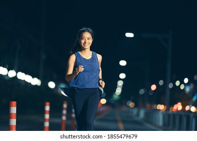 Asian Woman Practicing Running At Night