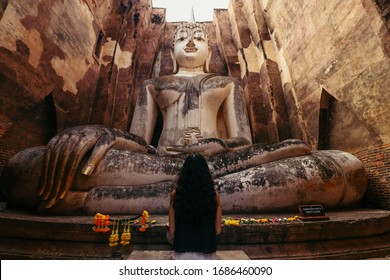 Asian woman praying : Wat Si Chum at Sukhothai Historical Park - Shutterstock ID 1686460090