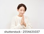 Asian woman praying in white background