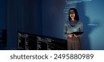 asian woman programmer standing in front of a screen with code projected  presentation the integration of technology and human expertise in software development