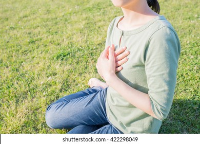 Asian Woman Putting Her Hands On The Chest