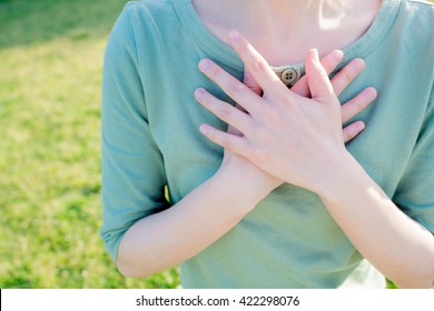 Asian Woman Putting Her Hands On The Chest