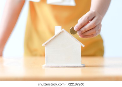 Asian Woman Putting Money Coin In To House Piggy Bank Metaphor Saving Money Financial For Buy The Home Shallow Depth Of Field Select Focus On House