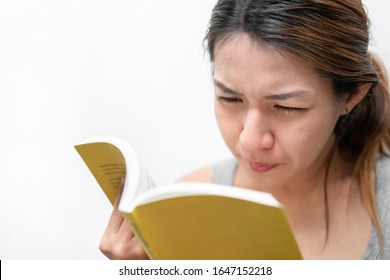 Asian Woman Reading Book, Has Bad Vision Sight Problems, Selective Focus, Myopia And Eyesight Problem Concept.