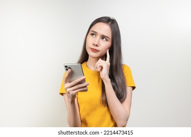 Asian woman reading news in mobile app and wondering fake news. - Shutterstock ID 2214473415