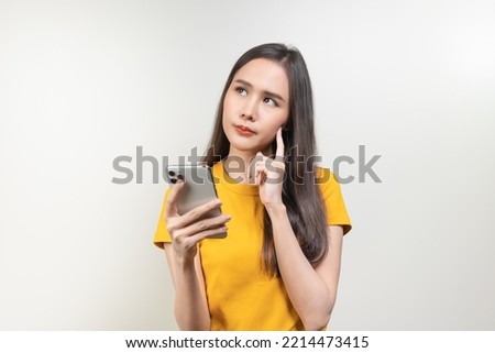 Asian woman reading news in mobile app and wondering fake news.