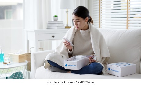 Asian Woman Receive Medication Package Box Free First Aid Kit From Pharmacy Hospital Delivery Service At Home In Telehealth Telemedicine Online Concept. Check Medicine Box Capsule Pack From Drugstore.
