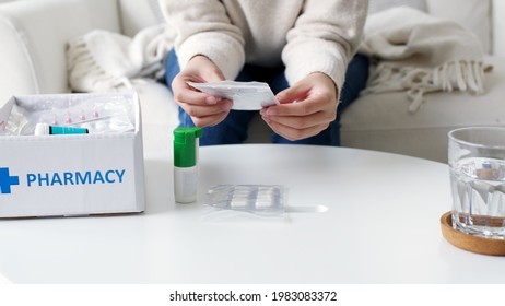 Asian Woman Receive Medication Package Box Free First Aid Kit From Pharmacy Hospital Delivery Service At Home In Telehealth Telemedicine Online Concept. Check Medicine Box Capsule Pack From Drugstore.