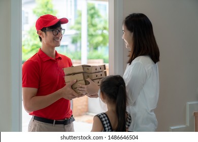 Asian Woman Recieve Pizza Box From Pizza Boy At The Home, Online Food, Online Order, Delivery Food And Lunch Concept