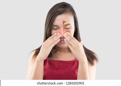 Asian woman in red wear feeling unwell because of sinus against a gray background. People caught a cold and fever. The concept of healthcare and allergy
