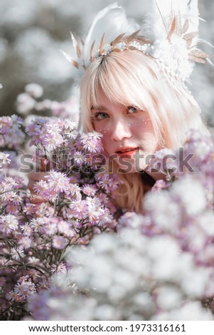 Similar – Schöne blonde Frau, die in der Nähe einer riesigen Blume posiert.