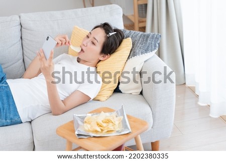 Asian woman relaxing on sofa