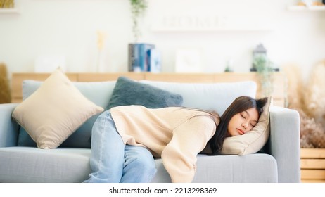 Asian woman resting at home on couch, feeling exhausted after work, lacking energy, or overworked, too tired, and lacking motivation - Shutterstock ID 2213298369
