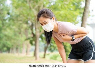 Asian Woman Runner Wearing Mask Has Chest Pain And Dizziness. Myocardial Infarction May Occur, See A Doctor. Concept Of The Dangers Of Exercise.