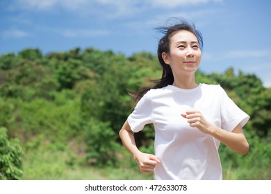 Asian Woman Running In The Park