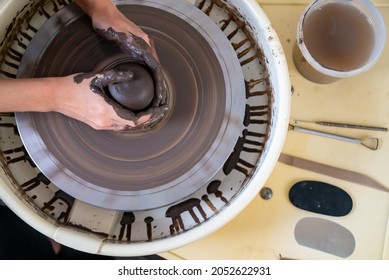 Asian woman sculptor artist hands sculpture clay on pottery wheel at ceramic studio. Female craftsman molding raw clay create pottery shapes at workshop. Small business handicraft product concept. - Powered by Shutterstock