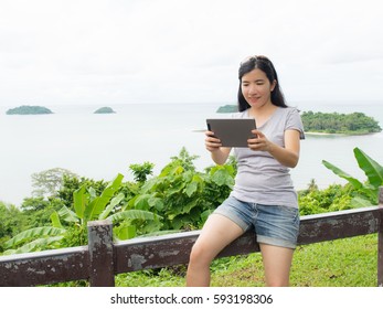 asian woman selfie with seascape against blue sky - Shutterstock ID 593198306