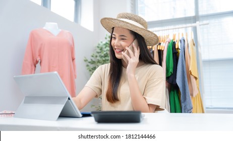 Asian Woman Selling Vintage Clothes, She Is Live On Social Media.She Is Answering Customers Questions.