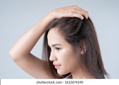 Asian Woman. She Is Shocked At The Damaged Hair.