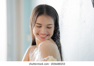 Asian woman She takes a shower and washes her hair in the bathroom - Shutterstock ID 2036680253