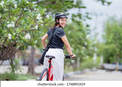 Asian Woman She Uses Bicycles To Work.She Is Smiling