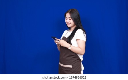 Asian Woman Shopkeeper Happy Look Phone Isolated Blue Background