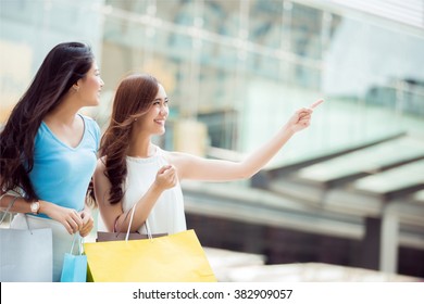 Asian Woman Shopping Discounted Products In A Mall. She Was Very Excited