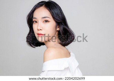 Asian woman short hair with Perfect clean fresh skin. Cute female model with natural makeup and sparkling eyes on white isolated background. Facial treatment, Cosmetology, beauty Concept.