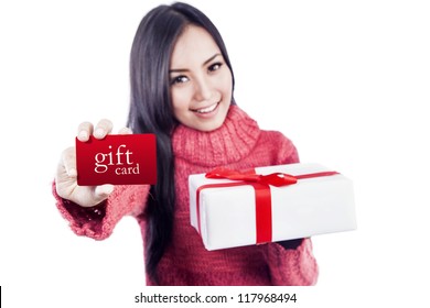 Asian Woman Is Showing A Gift Card While Holding A Present