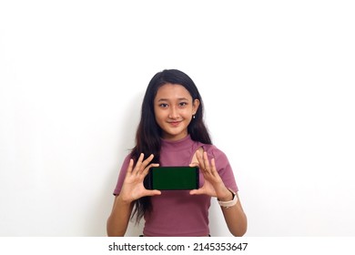 Asian Woman Showing Landscape Blank Screen Mobile Phone On Hand Isolated Over White Background