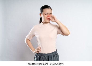 Asian Woman Was Sick With Fever, Sneezing And Rubbing Her Nose With Red Spot, Standing Isolated On White Background.