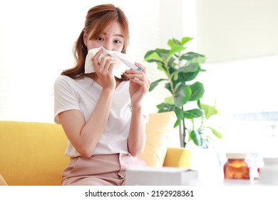 Asian Woman Sick With Flu Treating Herself At Home Hold A Digital Thermometer To Check Your Body Temperature. Concept Of Health Care