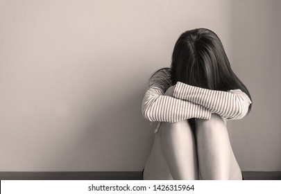 Asian woman sits and hugs knees up to the chest depression of lonely have a headache at home,Mental disorder health care,World suicide prevention day concept,Black and white toned