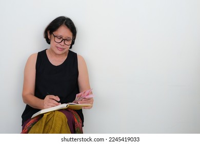 Asian woman sitting alone