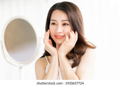 Asian Woman Sitting Makeup In Front Of Mirror